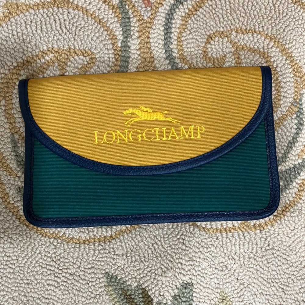 Longchamp green yellow coated canvas wallet with blue leather trim.
